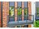 Exterior balcony featuring metal railings and brick accents, with surrounding trees at 1239 Chelsea Nw Cir, Atlanta, GA 30318