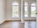 This bedroom boasts stunning arched windows, flooding the space with natural light and views at 1239 Chelsea Nw Cir, Atlanta, GA 30318