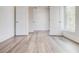 A clean, modern room showcasing sleek, wood-look floors and ample natural light at 1239 Chelsea Nw Cir, Atlanta, GA 30318