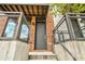 Close-up of a modern townhome entry with a sleek black door and concrete stairs at 1239 Chelsea Nw Cir, Atlanta, GA 30318