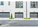 Exterior view of three townhome garages, each with a modern gray door and house number at 1239 Chelsea Nw Cir, Atlanta, GA 30318