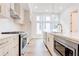 Modern kitchen with stainless steel appliances, a large island, and light wood cabinets at 1239 Chelsea Nw Cir, Atlanta, GA 30318