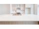 Spacious kitchen island with white countertop, stainless steel sink and sleek, modern faucet at 1239 Chelsea Nw Cir, Atlanta, GA 30318