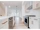 Bright open kitchen with stainless steel appliances, a kitchen island, and modern lighting at 1239 Chelsea Nw Cir, Atlanta, GA 30318
