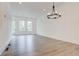 Open-concept living room with a modern chandelier and ample natural light at 1239 Chelsea Nw Cir, Atlanta, GA 30318