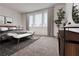 This bedroom features lots of natural light, neutral tones, a bench, and stylish decor at 1239 Chelsea Nw Cir, Atlanta, GA 30318
