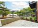 A cozy patio with a concrete base and a black metal railing, surrounded by lush greenery at 1239 Chelsea Nw Cir, Atlanta, GA 30318