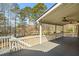 Outdoor deck with ceiling fans and white railing overlooking a beautiful lake and backyard at 2504 Loch View Sw Ct, Conyers, GA 30094
