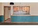 Basement bar area with wood cabinets, countertop, and pass-through window to the recreation room at 2504 Loch View Sw Ct, Conyers, GA 30094