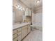 Well-lit bathroom features tiled floors, vanity with a sink, and a bathtub with shower at 2504 Loch View Sw Ct, Conyers, GA 30094