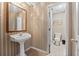 Charming bathroom with pedestal sink and tile flooring features neutral walls at 2504 Loch View Sw Ct, Conyers, GA 30094