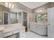 Bathroom with white vanity, framed mirrors, and recessed lighting above a tile floor at 2504 Loch View Sw Ct, Conyers, GA 30094