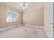 Cozy bedroom featuring a ceiling fan, a large window with blinds and a closet at 2504 Loch View Sw Ct, Conyers, GA 30094
