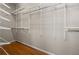 Walk-in closet with custom shelving and hanging racks for optimal storage and organization solutions at 2504 Loch View Sw Ct, Conyers, GA 30094