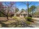Charming brick home with well-manicured lawn, mature trees, and inviting walkway at 2504 Loch View Sw Ct, Conyers, GA 30094