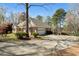 Beautiful home with a spacious driveway and an attached garage nestled among mature trees at 2504 Loch View Sw Ct, Conyers, GA 30094