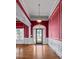 Grand foyer with decorative glass door, hardwood floors, and elegant chandelier at 2504 Loch View Sw Ct, Conyers, GA 30094