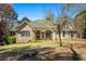 Charming single-story brick home with a manicured lawn and inviting front porch with white columns at 2504 Loch View Sw Ct, Conyers, GA 30094