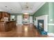 Spacious open-concept kitchen/living area with fireplace and green walls at 2504 Loch View Sw Ct, Conyers, GA 30094