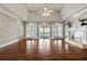 Spacious living room featuring hardwood floors, fireplace, and French doors to the outdoor deck at 2504 Loch View Sw Ct, Conyers, GA 30094