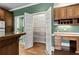 Spacious pantry with adjustable shelving, adjacent to a custom desk area and wood floors at 2504 Loch View Sw Ct, Conyers, GA 30094