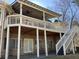 Spacious outdoor patio with brickwork, white columns and staircase to the backyard, perfect for entertaining guests at 2504 Loch View Sw Ct, Conyers, GA 30094