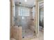 Large glass shower with tile surround, built-in seat, and natural light at 2504 Loch View Sw Ct, Conyers, GA 30094