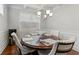 Dining room with coffered ceiling, a chandelier, and a round table at 736 Red Wolf Run, Atlanta, GA 30349
