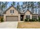 Charming one-story brick home with a well-manicured lawn and attached two-car garage at 736 Red Wolf Run, Atlanta, GA 30349