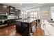 Modern kitchen with stainless steel appliances, granite countertops, and a large island with bar seating at 736 Red Wolf Run, Atlanta, GA 30349