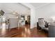 Open-concept living area with hardwood floors, neutral decor, and an adjacent kitchen and dining area at 736 Red Wolf Run, Atlanta, GA 30349