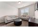 Cozy den with a comfortable gray sofa, loveseat, TV, and ample natural light at 736 Red Wolf Run, Atlanta, GA 30349