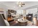 Open-concept living room with a comfortable sofa, kitchen, and a cozy seating area with natural light at 736 Red Wolf Run, Atlanta, GA 30349