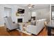 Comfortable living room with a fireplace, neutral-toned furniture, and open access to other areas at 736 Red Wolf Run, Atlanta, GA 30349