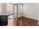 Bright office space featuring hardwood floors, a glass door to the outside and a modern black desk at 736 Red Wolf Run, Atlanta, GA 30349