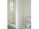 Bathroom featuring a shower with glass doors, a toilet, and neutral colors throughout the space at 179 Hunters Crk, Dallas, GA 30157