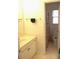 Bright bathroom with a vanity, mirror, and a glimpse into a tiled shower/tub area at 179 Hunters Crk, Dallas, GA 30157