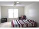 Bright bedroom with a large window, ceiling fan, and a cozy armchair beside a simple bed at 179 Hunters Crk, Dallas, GA 30157