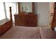 Spacious bedroom featuring a wooden dresser with a mirror and a bed in the foreground at 179 Hunters Crk, Dallas, GA 30157