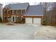 View of a two-story brick home with an attached two-car garage and a large driveway for convenient parking at 179 Hunters Crk, Dallas, GA 30157