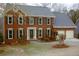 Charming two-story brick home with a well-manicured lawn, dark green shutters, and a two-car garage at 179 Hunters Crk, Dallas, GA 30157
