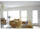 Inviting living room with a fireplace, neutral-toned sofas, and bright windows offering plenty of natural light at 179 Hunters Crk, Dallas, GA 30157