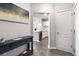 Inviting foyer showcasing wood floors leading to a modern kitchen with stainless steel appliances at 390 17Th Nw St # 5031, Atlanta, GA 30363