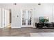 Spacious living room with hardwood floors and adjacent doorway to the bathroom at 390 17Th Nw St # 5031, Atlanta, GA 30363