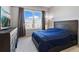 Comfortable main bedroom featuring plush carpet, a large window, and tasteful furnishings at 390 17Th Nw St # 5031, Atlanta, GA 30363