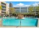 Community pool with lounge chairs and an arbor in an urban setting at 390 17Th Nw St # 5031, Atlanta, GA 30363