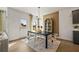 Bright dining area with hardwood floors, modern lighting, and access to the outdoors at 1629 Tide Mill Rd, Cumming, GA 30040