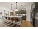 Modern kitchen with stainless steel appliances, a quartz island, and a breakfast bar at 1629 Tide Mill Rd, Cumming, GA 30040