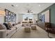 Stylish living room features neutral tones, ceiling fan, and large windows for ample natural light at 1629 Tide Mill Rd, Cumming, GA 30040