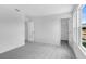 Carpeted bedroom featuring white walls, natural light from windows, and door leading to closet at 213 Groveton Ct, Euharlee, GA 30145